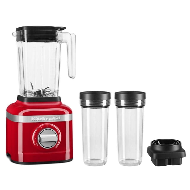 KitchenAid® 3 Speed Ice Crushing Blender with 2 Personal Blender Jars in red, featuring a 48-oz clear blender jar with black lid and handle, a red base with silver control dial, two clear 16-oz personal blending jars with black lids, and a black blade assembly, suitable for making smoothies and crushing ice efficiently.