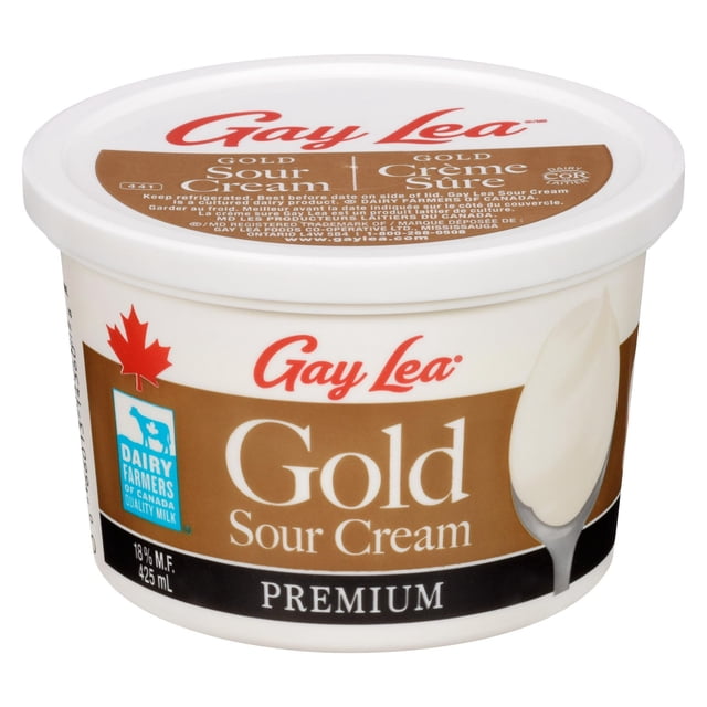 Gay Lea Foods Gay Lea Gold Sour Cream in a 425 ml white plastic tub with a brown label featuring the red Gay Lea logo, Canadian maple leaf, and Dairy Farmers of Canada quality milk symbol, containing 18% milk fat, ideal for tangy dips, salad dressings, and pairing with fresh apples, berries, and cinnamon.