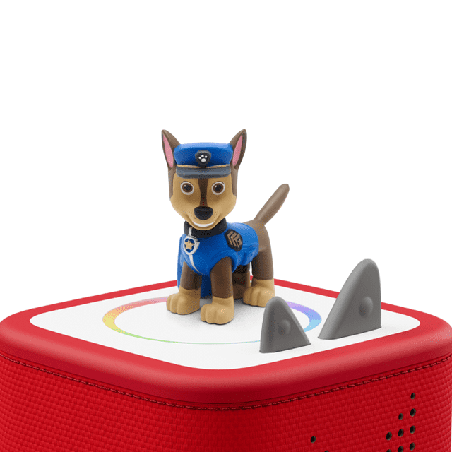 Tonies Audio Character - Paw Patrol Chase figure in blue police uniform with badges, standing on a red Toniebox speaker with a white top featuring a multicolored circular ring and two gray triangular control buttons.
