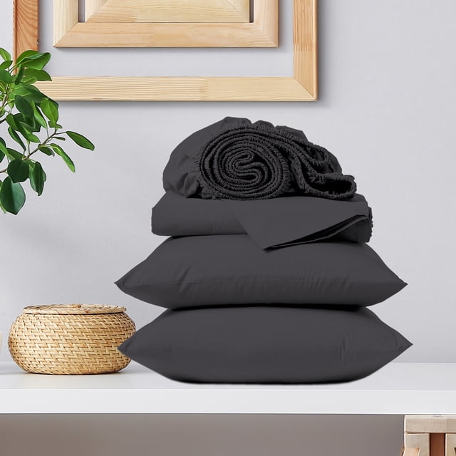 Draps de Lit 100 % Coton, Poche Profonde, Résistants aux Plis, Satin Doux et Lisse 3 Pcs, Lit Simple Gris Foncé par Color Sense. l'Ensemble Comprend un Drap-Housse avec Technologie Brevetée True Grip fit, un Drap Plat et une Taie d'Oreiller. Faits de Satin de Coton 300 Fils, Ces Draps Sont Résistants aux Plis, à Faible Boulochage et Durables. la Literie Gris Foncé Est Exposée Pliée et Empilée sur une surface Blanche, avec un Panier Décoratif et une Plante à Proximité.