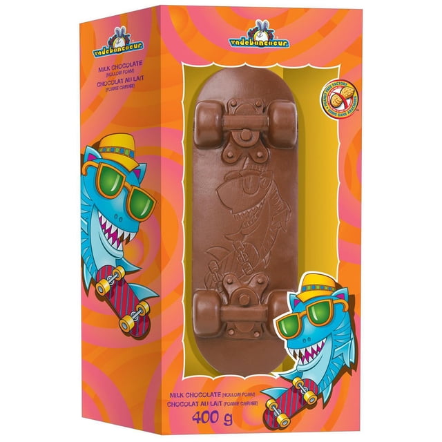 Freddo Skateboard hollow milk chocolate shaped as a skateboard with embossed shark design, detailed wheels and trucks, in a vibrant orange and pink box featuring cartoon shark illustrations and labeled 400g, suitable as a novelty chocolate gift.