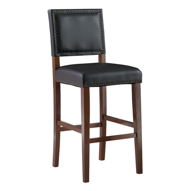 Garland Black Bar Stool with 30-inch height, padded black faux leather seat and backrest accented with antique bronze nailhead trim, supported by solid cherry stained wood legs with footrests, suitable for kitchen or home pub seating and bar heights of 41 to 43 inches.