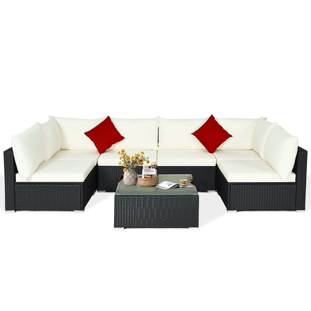 Patiojoy 7-Piece Patio PE Rattan Sectional Sofa Furniture Set with beige cushions and black wicker frame. Includes 4 armless sofas, 2 corner sofas, and 1 coffee table with tempered glass top. Modular sectional design allows flexible arrangements. Crafted with weather-resistant and fade-resistant materials, ideal for patios, gardens, backyards, and poolside areas.