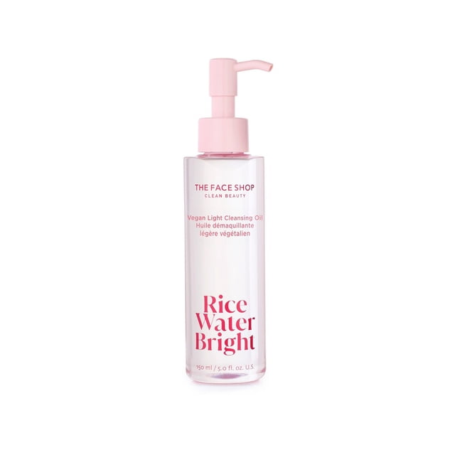 The Face Shop Rice Water Bright Vegan Light Cleansing Oil in a clear 150 ml bottle with a pink pump dispenser and red text, a lightweight Korean skin care makeup remover suitable for all skin types including oily and combination skin.