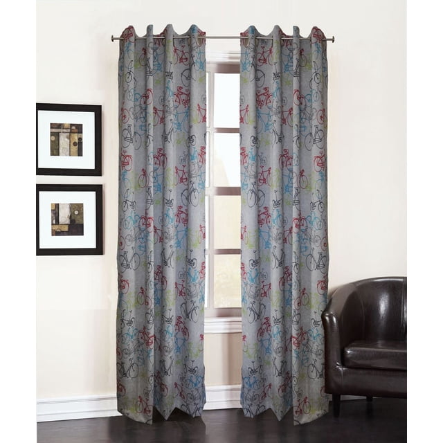 Sun Zero Madrid Print Grommet Curtains in grey with multicolored bicycle print, set of 2 room darkening energy efficient panels measuring 40 by 63 inches, machine washable for easy maintenance, hanging on a metal rod in a room with white walls, dark hardwood floor, framed abstract art, and a dark brown leather armchair. Suitable for adding a playful accent to casual living spaces or children's rooms.