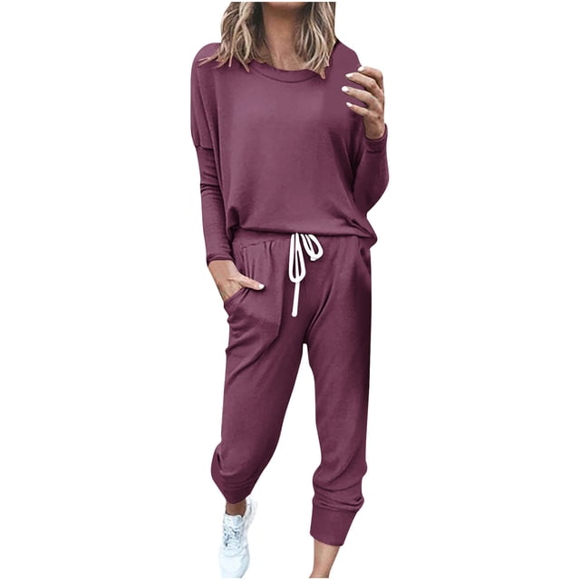 Womens Printing Round Neck Long Sleeve Solid Two-piece Comfortable Home Pajamas Pocket Set Sports Set. The set includes a long-sleeve top with a round neckline and matching pants with an adjustable drawstring waist and side pockets. Made from cotton, it features a casual fit with great elasticity, suitable for daily or casual wear. The outfit is shown in a solid maroon colour, styled with white sneakers.