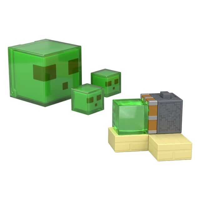 Minecraft Redstone Charged Sticky Piston Trap Set with Action Figure, Accessories & Moving Mechanism showing a large translucent green slime block figure with pixelated face, two smaller slime block figures, and a gray sticky piston trap on beige base blocks, suitable for action role play and collectible display.