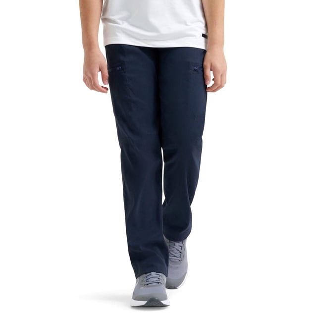 Wrangler® Boy's All Terrain Cargo Pant in navy blue, straight fit with comfort stretch waistband, moisture-wicking fabric, UPF 40+ sun protection, and two zippered tech pockets, shown front-facing on a boy wearing grey sneakers and a white shirt, ideal for active outdoor use.