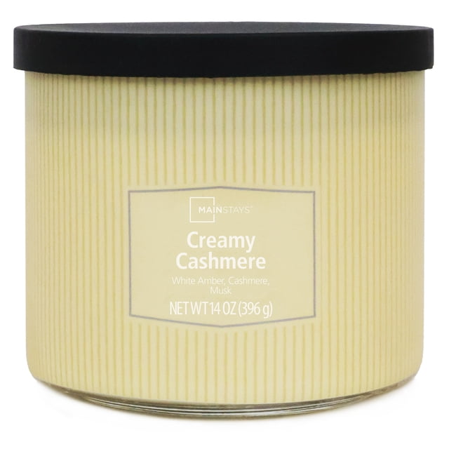Mainstays 3-Wick Textured Wrapped Cremey Cashmere Scented Candle, 14 oz, in a ribbed cream glass jar with black lid, scented with white amber, cashmere, and musk, providing a clean, even burn ideal for home décor and relaxation.