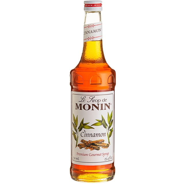 Monin 750 ml Sirop Aromatisant à la Cannelle de Qualité Supérieure dans une Bouteille en Verre Élégante à la Teinte Ambre Chaleureuse. l'Étiquette Présente des Bâtonnets de Cannelle et des Feuilles Vertes, Mettant en Valeur Sa Riche Saveur Naturelle de Cannelle. Idéal pour Rehausser les Cafés, les Lattés et les cocktails, Ce Sirop Est Fait avec du Sucre de Canne Pur et Ne Contient Pas d'Ingrédients Artificiels. Convient aux Véganes et aux Sans Produits Laitiers, Il Offre 25 Portions par Bouteille et Est compatible avec une Pompe à