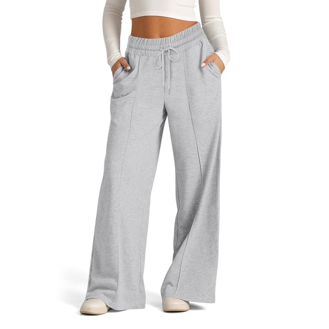 Pisexur Womens Sweatpants 2024 Ribbed Workout Jogging Pants in grey, featuring a casual baggy design with an elastic waistband, drawstring, and wide straight legs. These sweatpants include side pockets and are made of soft, breathable polyester fabric, suitable for daily wear, workouts, or lounging. Shown paired with a white cropped top and sneakers.