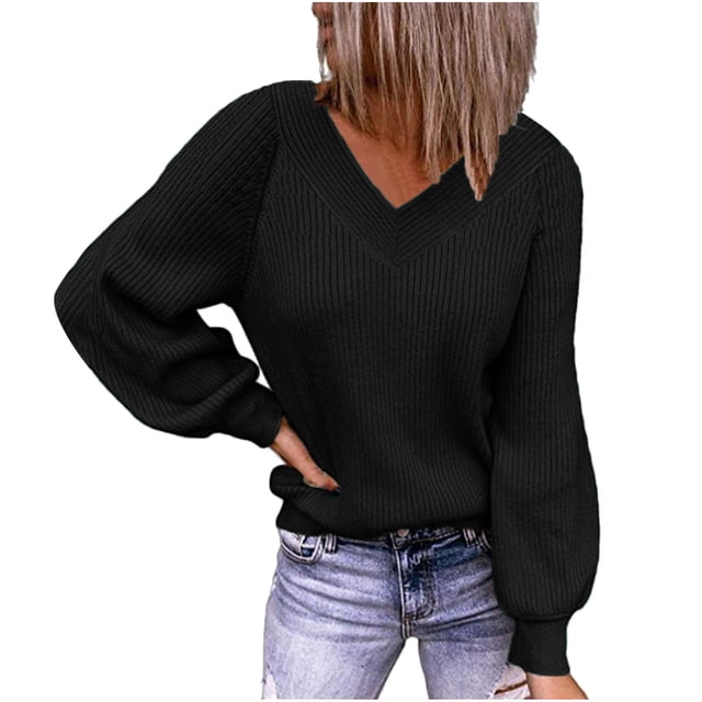 Fall Sweaters for Women V Neck Long Sleeve Solid Color Ribbed Pullover Sweaters. The image shows a black ribbed sweater with a V-neckline and long puffed sleeves, styled casually with light-wash jeans. The sweater has a loose and comfortable fit, ideal for casual wear during cooler seasons.
