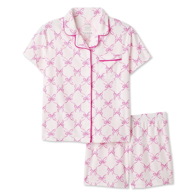 George Girls' Two Piece Lush Knit Pajama Set with short-sleeve button-up shirt featuring notch collar, chest patch pocket, and pink piping, paired with elastic waistband shorts, both in white lush knit fabric with pink bow print, suitable for comfortable sleepwear and casual lounging.