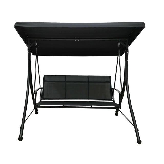 Dura Verdun 3-Seater Swing front-facing view of the three-seater patio swing with steel frame, Sling-tex weather-resistant seat and back, and polyester fabric canopy; rated 600 lb maximum capacity, shown on a sunlit porch setting, suitable for outdoor lounging and often used as a relaxed indoor reading nook.