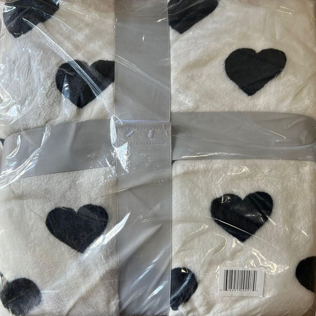 Johnson Home polyester plush blanket featuring black hearts on white background, packaged with gray ribbon and clear plastic.