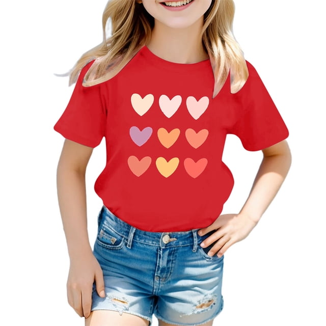 B91xZ Girls Tops 2024 Printing Tee with Short Sleeves in red, designed for 5-6-year-old girls. This casual summer T-shirt features a round neck, short sleeves, and a cute graphic print of multicoloured hearts on the front. Made from a soft and breathable cotton blend, it offers comfort and durability for regular wear. The girl in the image pairs the T-shirt with denim shorts, showcasing a playful and casual outfit.