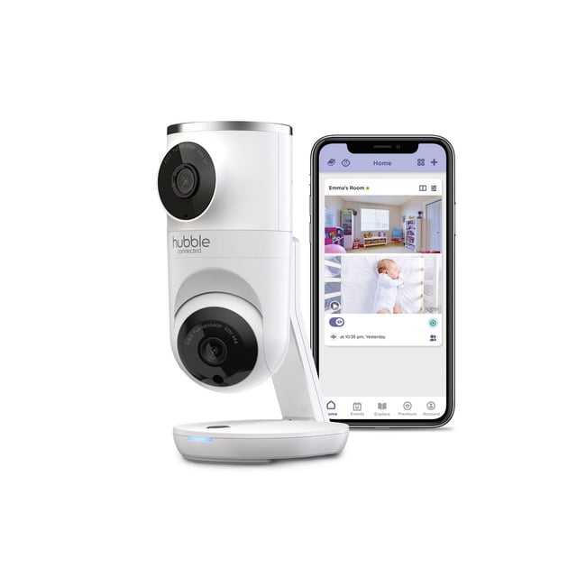 Hubble Connected Nursery Pal Dual Vision Cam, a white smart HD dual camera baby monitor with dual lenses for normal and wide-angle views, shown next to a smartphone displaying a nursery monitoring app with split-screen live video and room overview.
