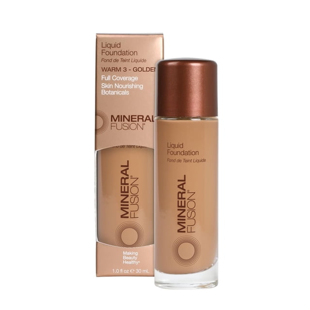 Mineral Fusion Liquid Foundation in Warm 3 Golden shade, full coverage with skin nourishing botanicals, shown in a 30 mL clear glass bottle with bronze cap next to its beige and bronze box packaging, ideal for medium to tan skin with golden undertones.