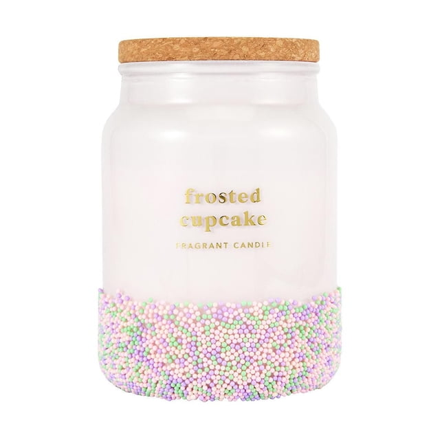 Anko Sprinkle Candle Cupcake in a frosted white jar with a cork lid, decorated with pastel sprinkles around the base and gold lettering. This single wick jar candle features a refreshing blueberry and sugarcane scent, ideal for cozy home décor.