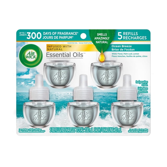 Air Wick Plug In Air Freshener, Scented Oil, 5 Refills, Ocean Breeze featuring five clear glass refill bottles with white caps on an ocean background, infused with natural essential oils of white floral, palm leaf, and lemon, each 20 ml refill delivers up to 60 days of continuous fragrance with Air Wick plug-in warmer.