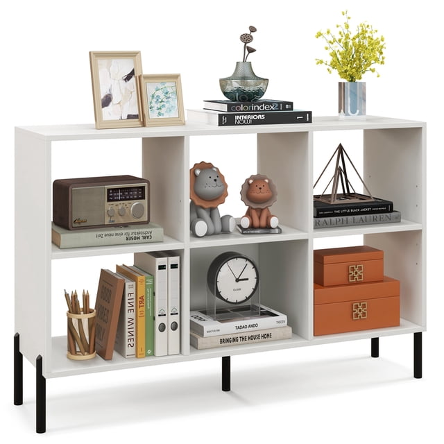 Costway 6 Cube Storage Shelf Organizer Bedroom Bookcase Square Cubby Cabinet in white. This 3-tier bookcase features six open cubes and a spacious tabletop for storage and display. Two adjustable shelves with five positions each allow customization for varied item heights. The bookcase is supported by five sturdy metal legs, including a central leg for added stability, and includes two anti-tip kits for safety. The white engineered wood construction has a waterproof surface for easy cleaning. Suitable for living rooms, bedrooms, or home offices.