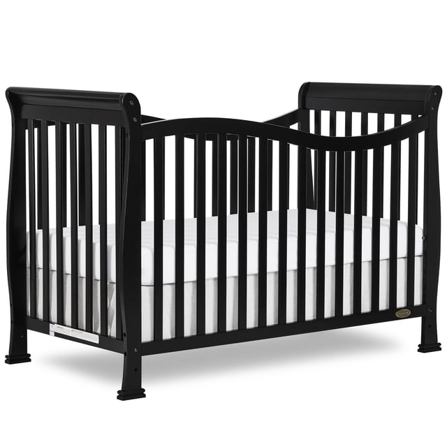 Dream On Me Violet 7-in-1 Convertible LifeStyle Crib in black, shown in a 3/4 front view with curved top rails and vertical slats crafted from solid New Zealand pinewood, fitted with a white mattress, designed for nursery use with multiple conversion options to toddler and full-size beds.