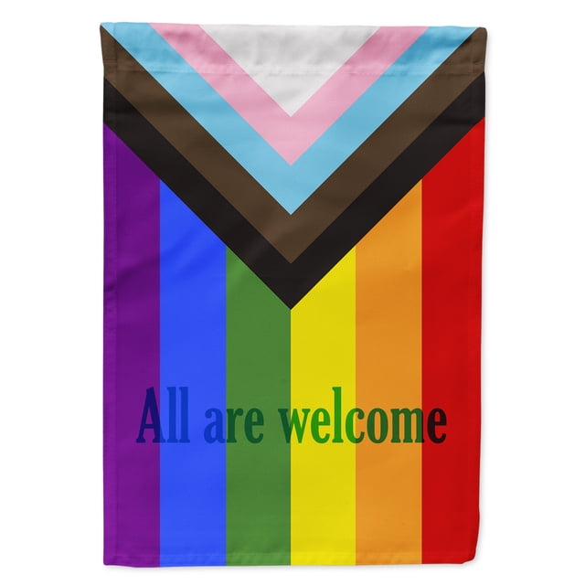 Carolines Treasures CK7990GF Gay Pride Progress Pride All are Welcome Flag Garden Size. This double-sided garden flag features the Progress Pride design with vibrant rainbow stripes and a chevron pattern in pink, blue, white, brown, and black. The text 'All are welcome' is printed in bold letters on the front and is readable on both sides. Made from thick, water-resistant, and weatherproof polyester fabric, the flag measures approximately 11 1/4 inches by 15 1/2 inches and includes a 1 1/2 inch sleeve for easy attachment to a standard garden flag stand or porch hanger. Garden stand sold separately.