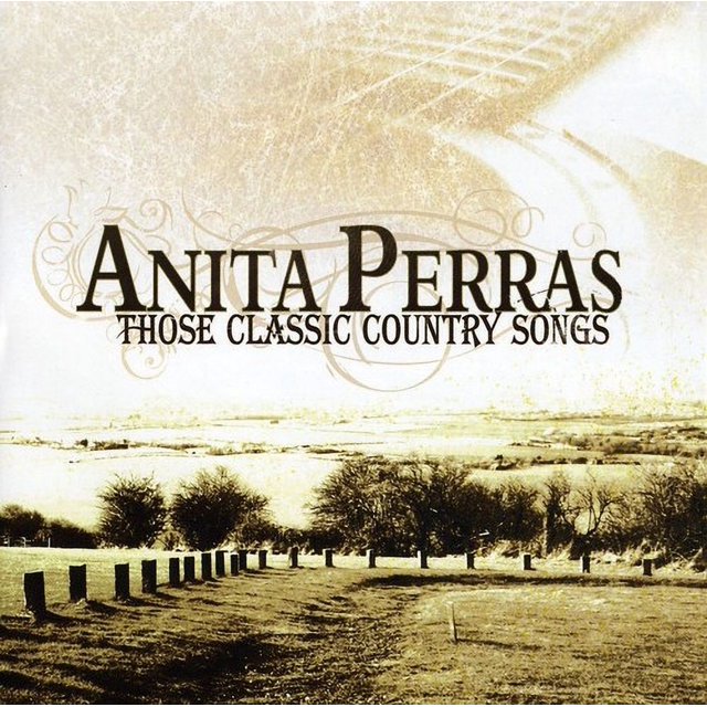 The album cover for 'Those Classic Country Songs' by Anita Perras, released by True North on April 21, 2009, in CD format. The design features a sepia-toned rural landscape with trees, a dirt path, and a decorative title font.