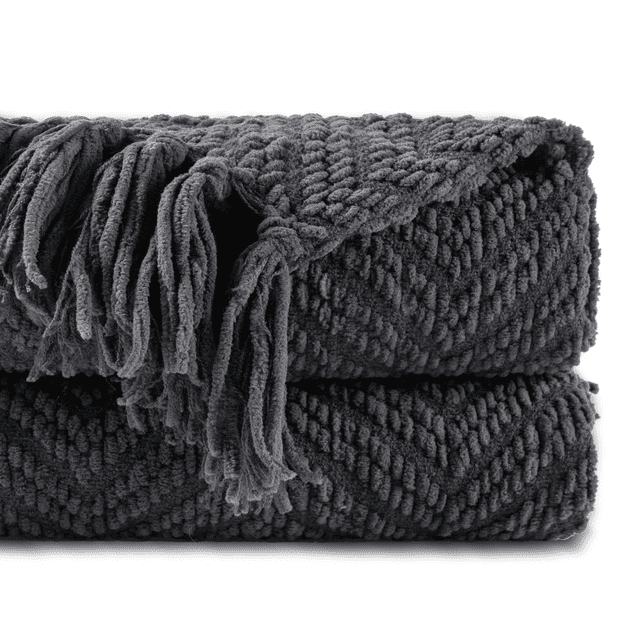 Battilo Grey Throw Blanket for Couch, a 50'' x 60'' knitted herringbone throw made of 100% acrylic, featuring a soft and cozy texture with rolled fringed edges. Ideal for home decor, adding warmth to a living room chair, bed, or sofa, and suitable as a Christmas gift or for camping.