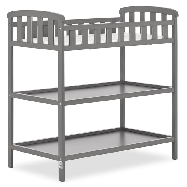 Dream On Me, Emily Changing Table in grey with solid pine wood construction, safety rails on all four sides, two spacious shelves below, and a 1-inch changing pad with safety strap on top, measuring 36.5L x 21.5W x 38.3H inches, meeting all safety standards.