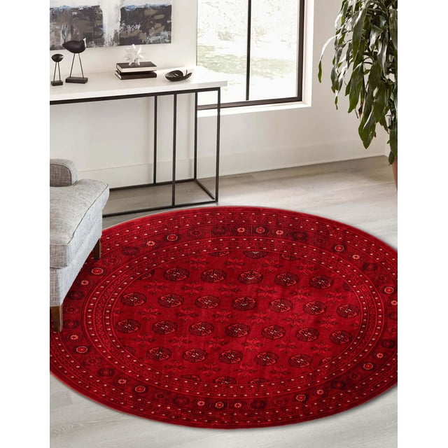 Tekke Oriental Area Rug for Living Room, Dining Room, Bedroom with a round shape and deep red color featuring symmetrical oval and diamond-shaped motifs, placed on light hardwood floor near a gray armchair and white console table with black metal legs, illuminated by natural light, often used as an accent rug to enhance room warmth and style.