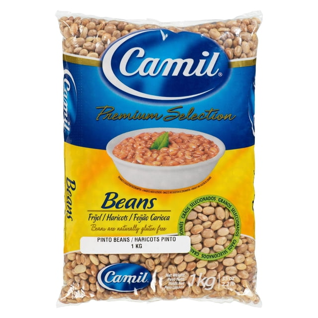 Camil Pinto Beans 1 kg bag of dried beans in a clear plastic package with a blue and yellow label featuring the Camil logo and a bowl of cooked beans garnished with a green leaf, highlighting its rich vegetable protein and iron content, suitable for pantry food and everyday meals.