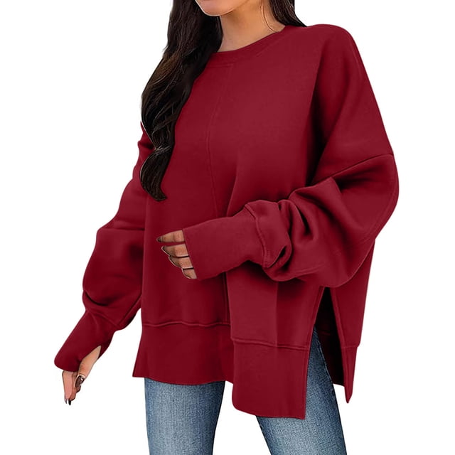 Timegard Oversized Sweatshirt for Women with a loose fit, long sleeves, thumb holes, and side splits. Crafted from soft, breathable fabric in a deep red shade, this pullover is ideal for fall and winter. Styled with blue jeans, it offers a casual and cozy look.