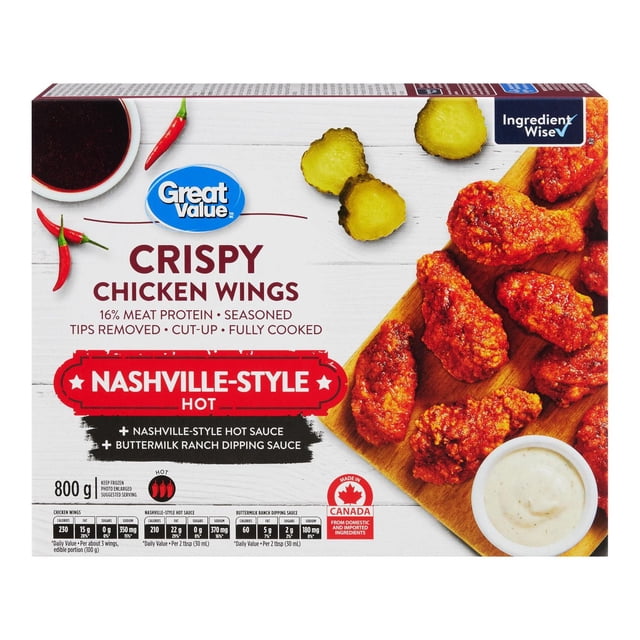 Great Value Nashville-Style Hot Crispy Chicken Wings package showing fully cooked, seasoned chicken wings coated in Nashville-style hot sauce on a wooden board with sliced pickles and a bowl of buttermilk ranch dipping sauce, with chili peppers and nutrition information on the box.