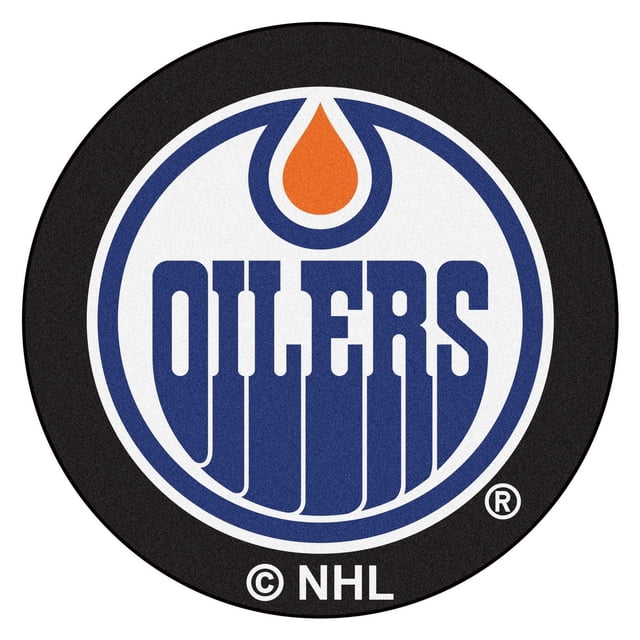 NHL Edmonton Oilers Hockey Puck Rug, a 27-inch round nylon carpet featuring the official Edmonton Oilers logo in blue and orange on a black puck background, with non-skid recycled vinyl backing and machine washable design, suitable as a doorway mat or fan room accent.