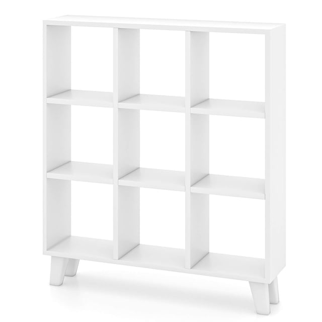 Costway 1 PCS 9-Cube Bookcase with 6 removable shelves and raised support feet in white. This freestanding bookshelf features a modern design with 9 open cubes for versatile storage and display. Made of engineered wood with thickened panels, it offers durability and a maximum weight capacity of 200 lbs. The raised feet provide 5 inches of clearance for easy cleaning and additional storage underneath. Dimensions are 35 inches long, 8 inches wide, and 39.5 inches high.