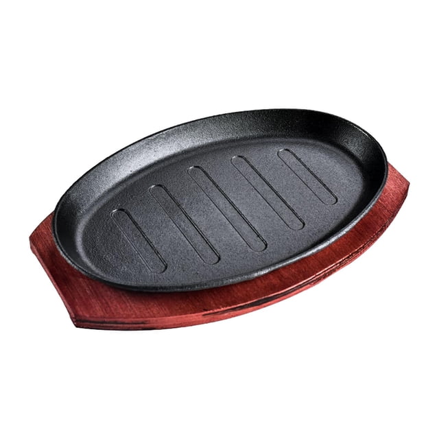 GROWTH TANK Griddle Steak Fry Plate Fajita Sizzling Pan in an oval shape, made of cast iron with a nonstick surface, paired with a bamboo tray. The black griddle pan features ridges for grilling and measures approximately 9.06 inches by 5.71 inches. The bamboo tray provides a convenient base for serving and handling the hot plate.