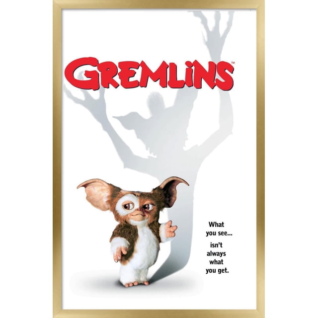 Gremlins - One Sheet Wall Poster, 22.375" x 34" depicting a small furry creature with large ears standing on a white background, casting a shadow of a larger clawed figure. The poster features bold red 'GREMLINS' text above and the phrase 'What you see... isn't always what you get.' on the right, ideal for wall art or themed room décor.