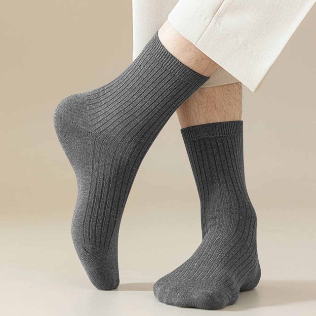 RKSTN Mens Socks 5PC Winter Solid Color Comfortable Breathable Knitted Cotton Socks displayed in a close-up view. The socks feature a ribbed texture in a solid grey color, made from coral fleece for warmth and breathability. Designed for winter and spring, they include reinforced heel and toe for durability and a snug fit. Ideal for casual and athletic wear.