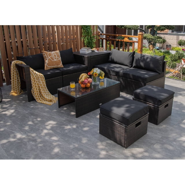 Costway 8PCS Patio Rattan Furniture Set with mix brown PE rattan and black cushions. Includes a tempered glass coffee table, storage box, two ottomans, two armless sofas, and two corner sofas arranged in an outdoor patio setting. This modular outdoor conversation set offers flexible layouts and space-saving storage. Ideal for gardens, patios, poolside, and backyard use.