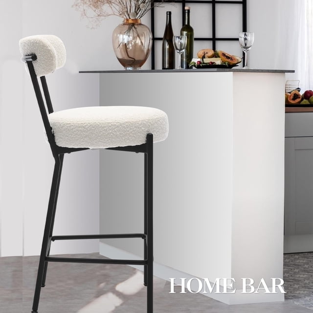 BeesClover Boucle Bar Stools Set of 2, featuring 26-inch counter height chairs with boucle upholstery and sturdy black metal legs. These modern bar stools include supportive backrests, plush 4-inch thick cushions, and footrests for ergonomic comfort. Displayed in a contemporary kitchen setting with a white island and decorative accents.