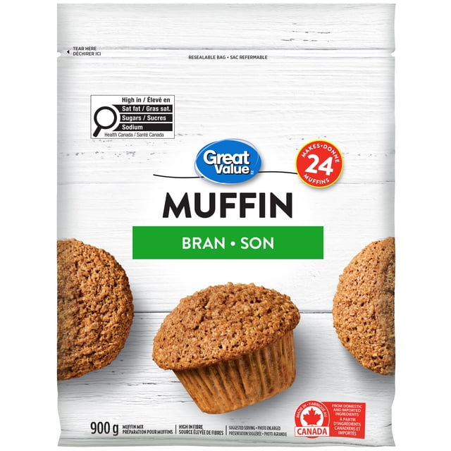 Great Value Bran Muffin Mix resealable 900 g bag with white wood background, featuring three bran muffins and text stating it makes 24 muffins, is high in fibre, and made in Canada from domestic and imported ingredients, often used for quick homemade baking.
