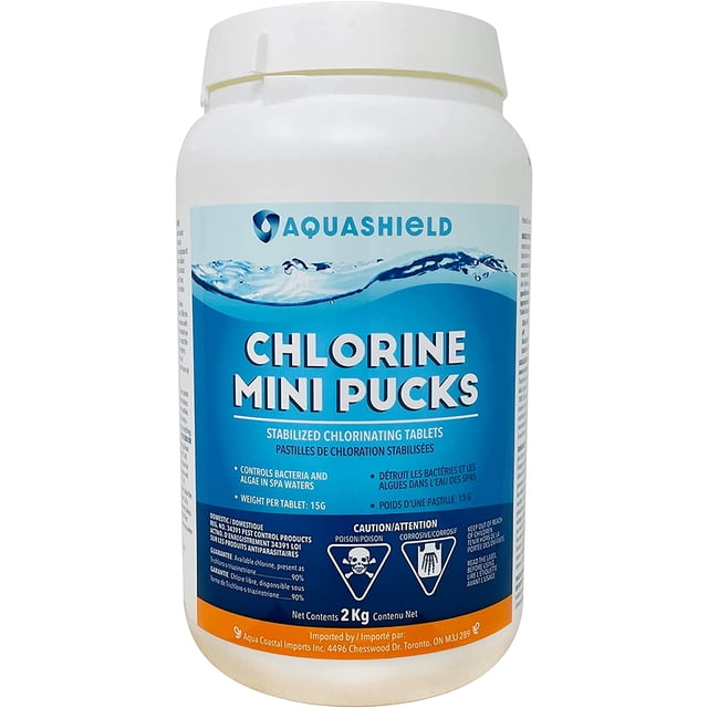Aquashield Spa 1" Chlorine Stabilized Mini Pucks (2 Kg) in a white plastic container with a blue label. The label highlights the product's features, including stabilized chlorinating tablets that control bacteria, prevent algae growth, and maintain safe water for pools and spas. Each puck weighs 15 grams and is slow-dissolving for long-lasting sanitation. The container includes safety warnings and usage instructions.