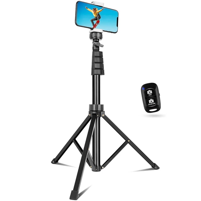 Adjustable 62" cell phone tripod with a black aluminum alloy frame, shown extended with a smartphone mounted horizontally. Features a 360-degree rotation head and a universal phone holder compatible with iPhone and Android devices. Includes a wireless Bluetooth remote for hands-free operation, displayed next to the tripod.