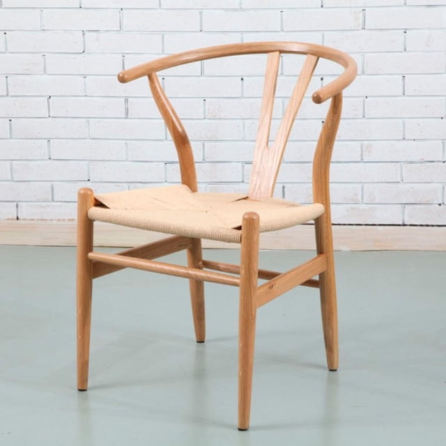 Heavenly Collection Wishbone Wood Dining Chair in natural colour with a solid ash wood frame and beige braided rope seat, featuring a curved backrest with Y-shaped support, suitable for kitchen or dining room seating, measuring 28.5 inches high, 22 inches wide, and 21 inches deep, displayed against a white brick wall and light grey floor.