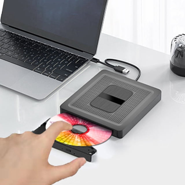 External Optical Drive with USB 3.0 and Type-C connectivity, shown in use with a laptop. The portable CD/DVD burner features a slim, lightweight design with a textured black finish. A hand is seen inserting a colourful disc into the drive, which is connected to the laptop via a USB cable. Ideal for reading and burning CDs/DVDs, it supports multiple systems including Windows and OSX, and offers a 5Gbps transmission rate. The drive includes a built-in data cable storage compartment for convenience.