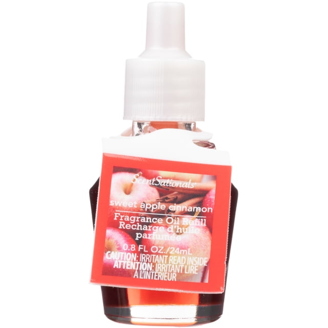 ScentSationals Scent Charm Oil - Sweet Apple Cinnamon fragrance oil refill in a clear glass bottle with white plastic cap and red label featuring apples and cinnamon, 0.8 fl oz (24 mL), for use with ScentSationals air freshener diffusers to freshen rooms.