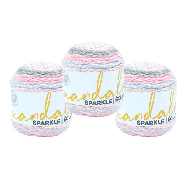 Lion Brand Mandala Sparkle Yarn - Aquarius showing three pastel yarn cakes in pink, blue, and gray tones with metallic thread for sparkle, each wrapped in a white label with gold and black text, suitable for knitting shawls, hats, or baby blankets.