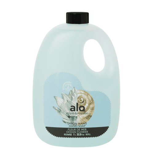 Fruits & Passion Alo Ocean Flower Hand Soap Refill, 33.8 ounces, designed for hand care in a recyclable bottle with a light blue design featuring a seashell and lotus flower graphic. The eco-friendly, biodegradable formula is enriched with vitamins E and B5, offering hydrating and antioxidant properties. Made in Canada.