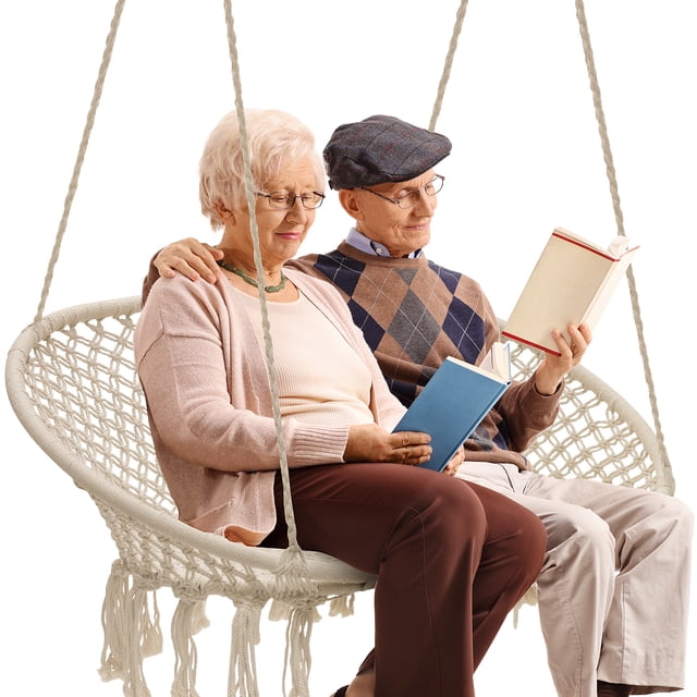 Sorbus Double Hammock Chair Macramé Swing with a 300-pound capacity, featuring a bohemian-style bench frame and macramé net design. Ideal as a hanging chair or porch swing for indoor or outdoor use, such as patios, gardens, or decks. Two people are seated on the swing, reading books.